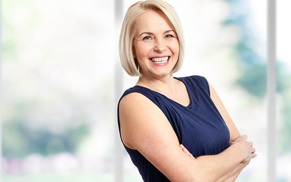 smiling woman with her arms crossed