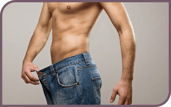 Image of a man wearing jeans that are too big on him