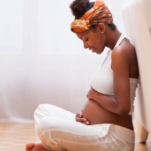 woman pregnant sitting on ground