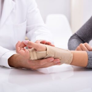 Doctor putting a brace on someone's hand. 