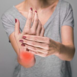 a person holding their hand in pain