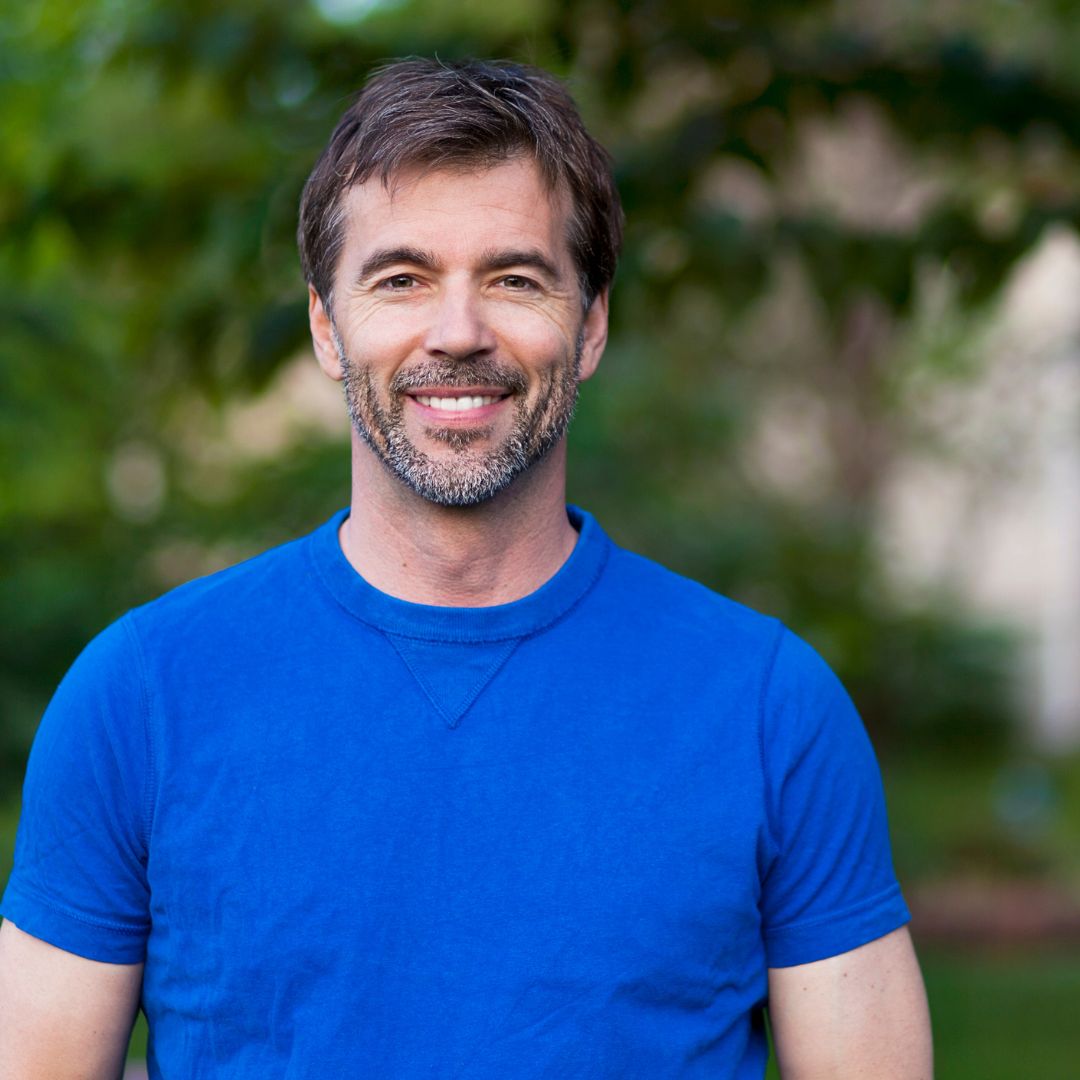 smiling man in blue shirt