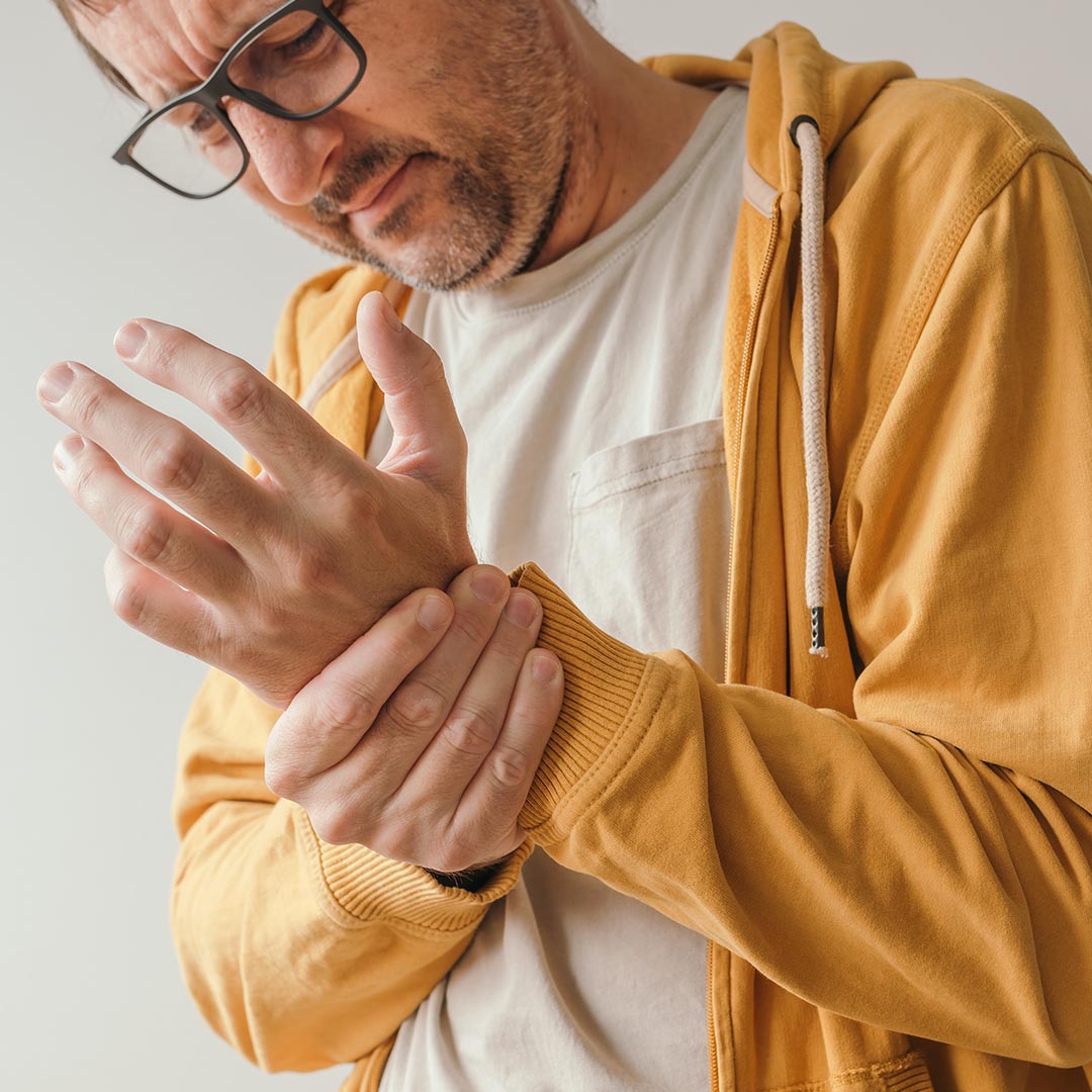 man holding his wrist in pain