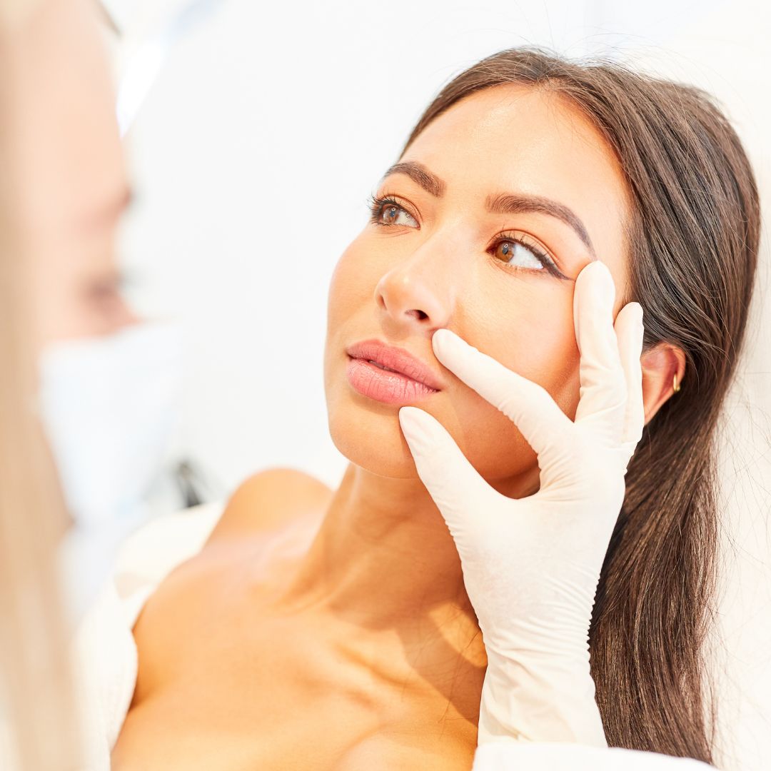 a woman having her face examined