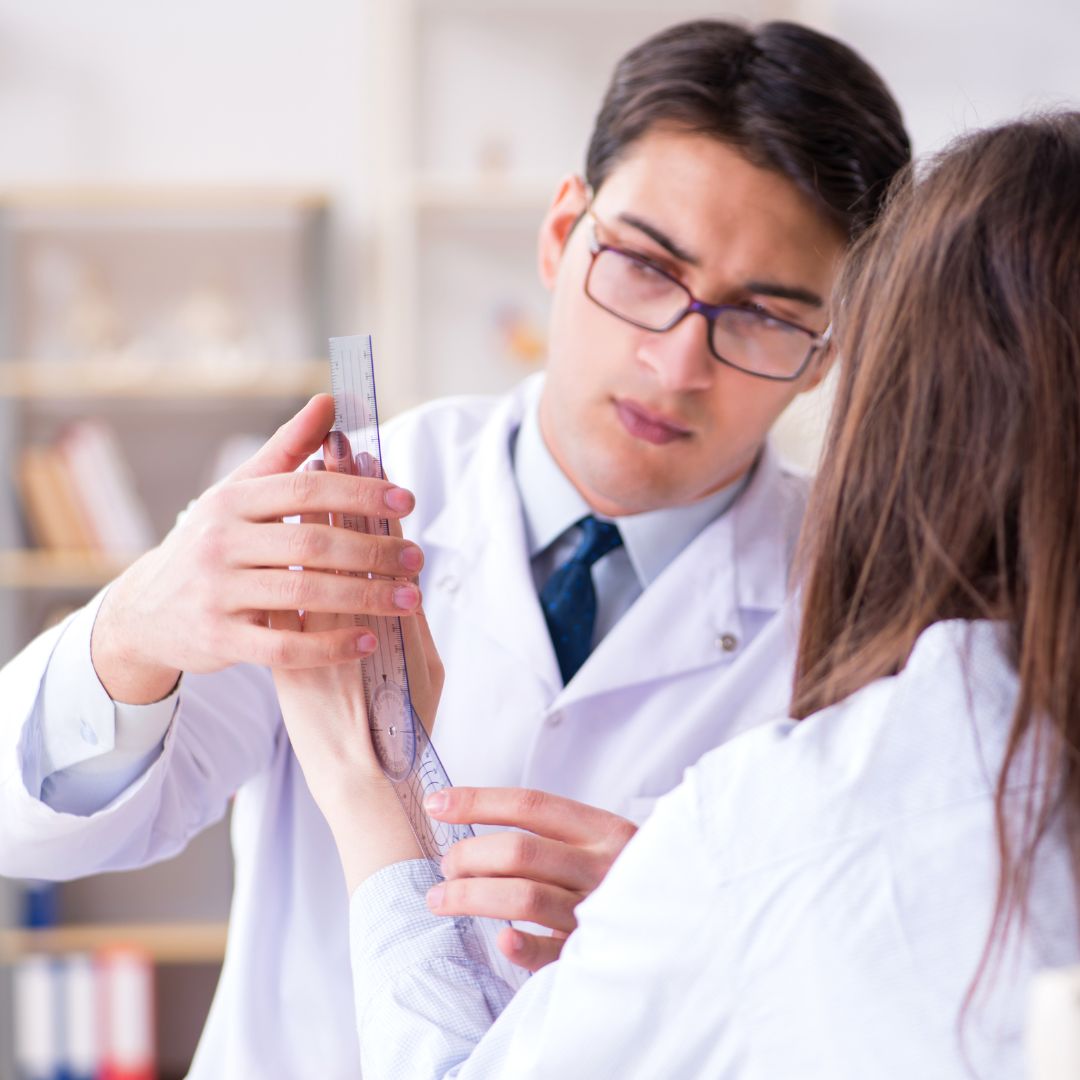 a doctor looking at a woman's hand