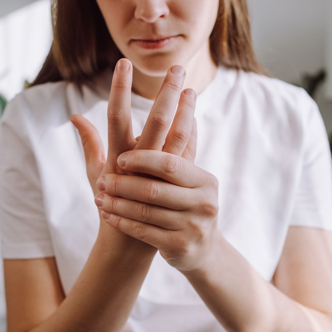 a person holding their hand in pain
