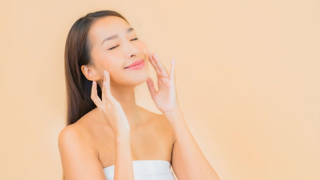 a woman smiling while lifting her cheeks