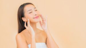 a woman smiling while lifting her cheeks