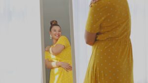 woman hugging body in mirror