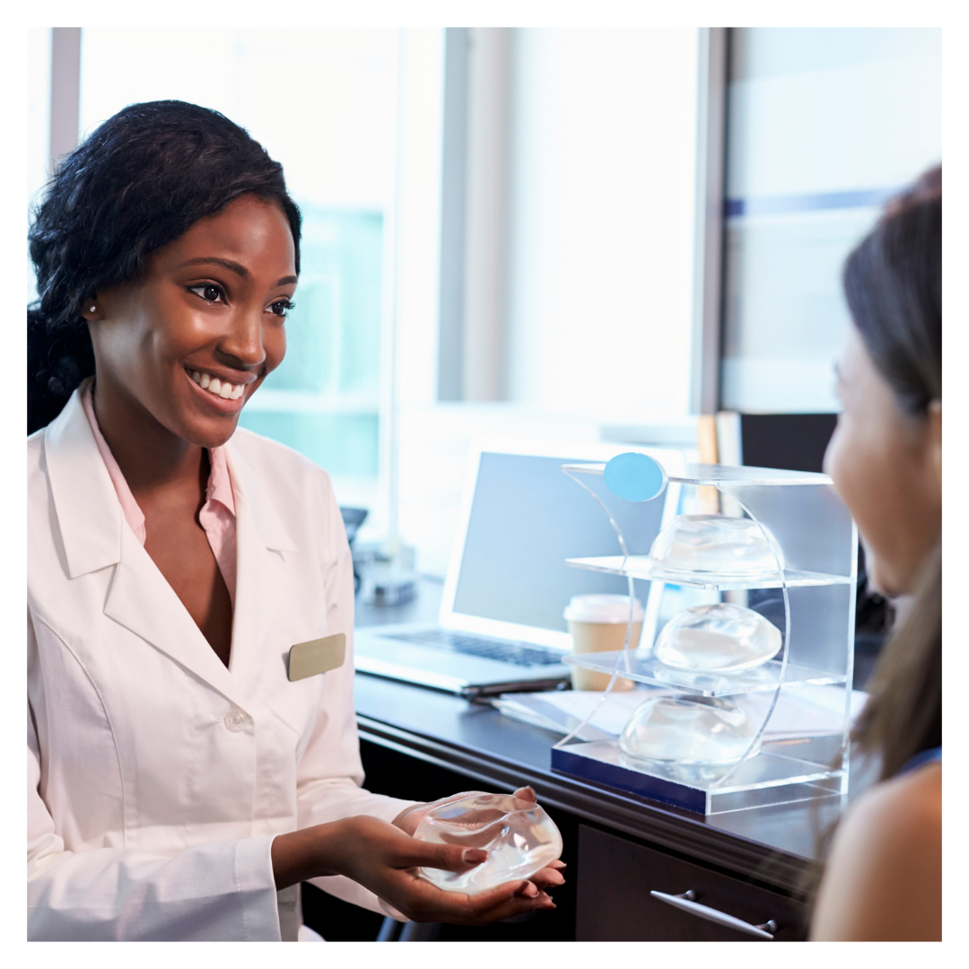 doctor showing woman breast implants
