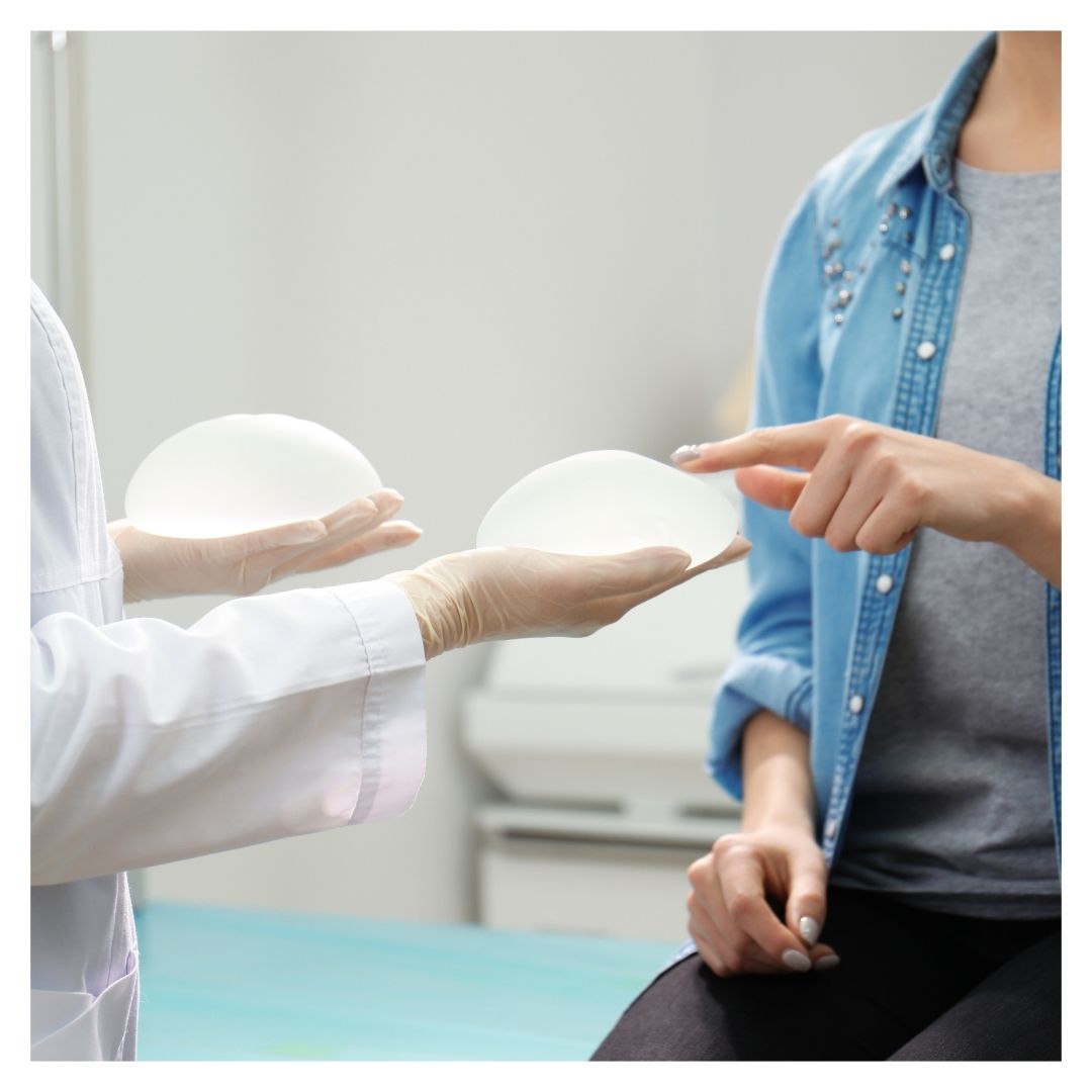 a woman examining a breast implant