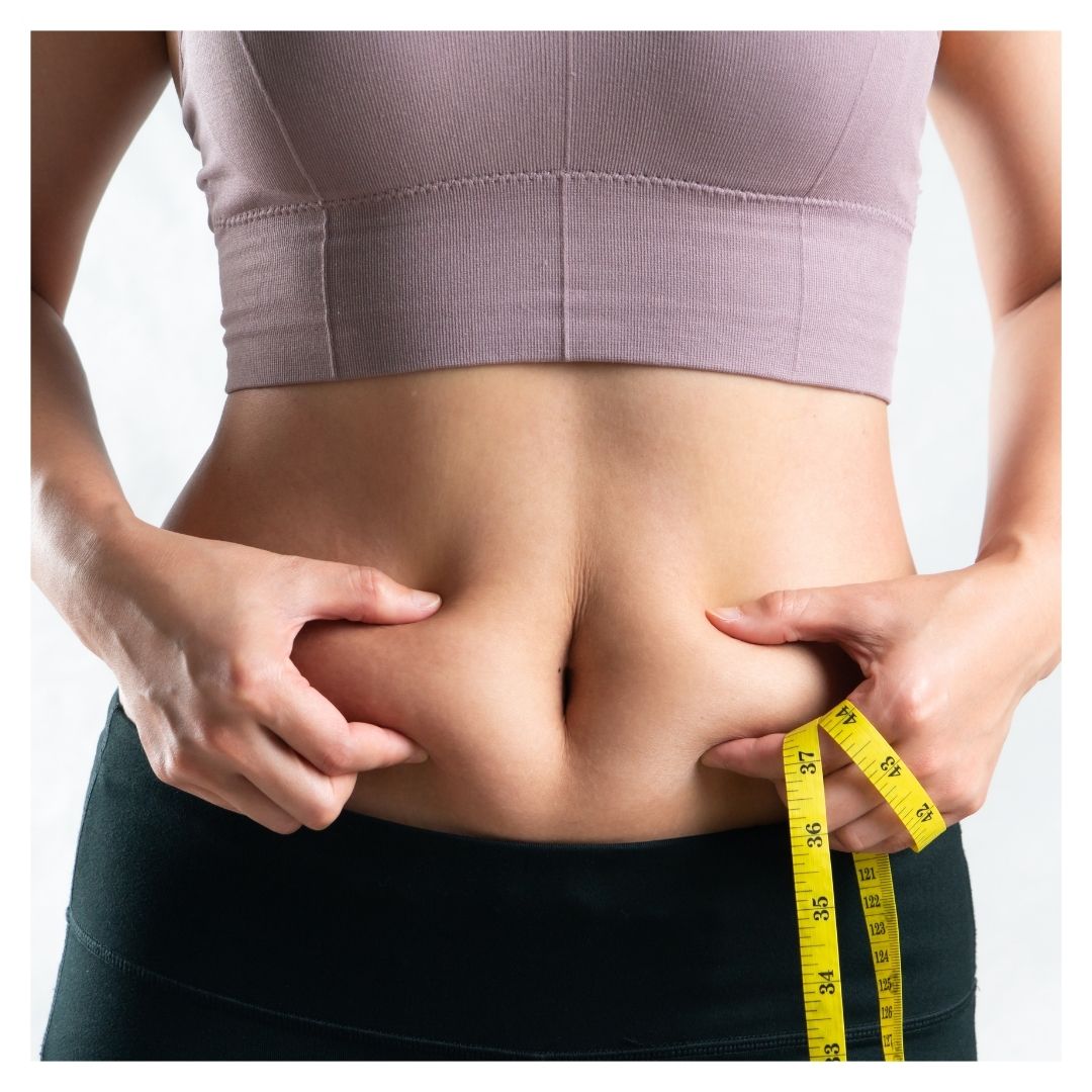 a woman squeezing her excess belly fat