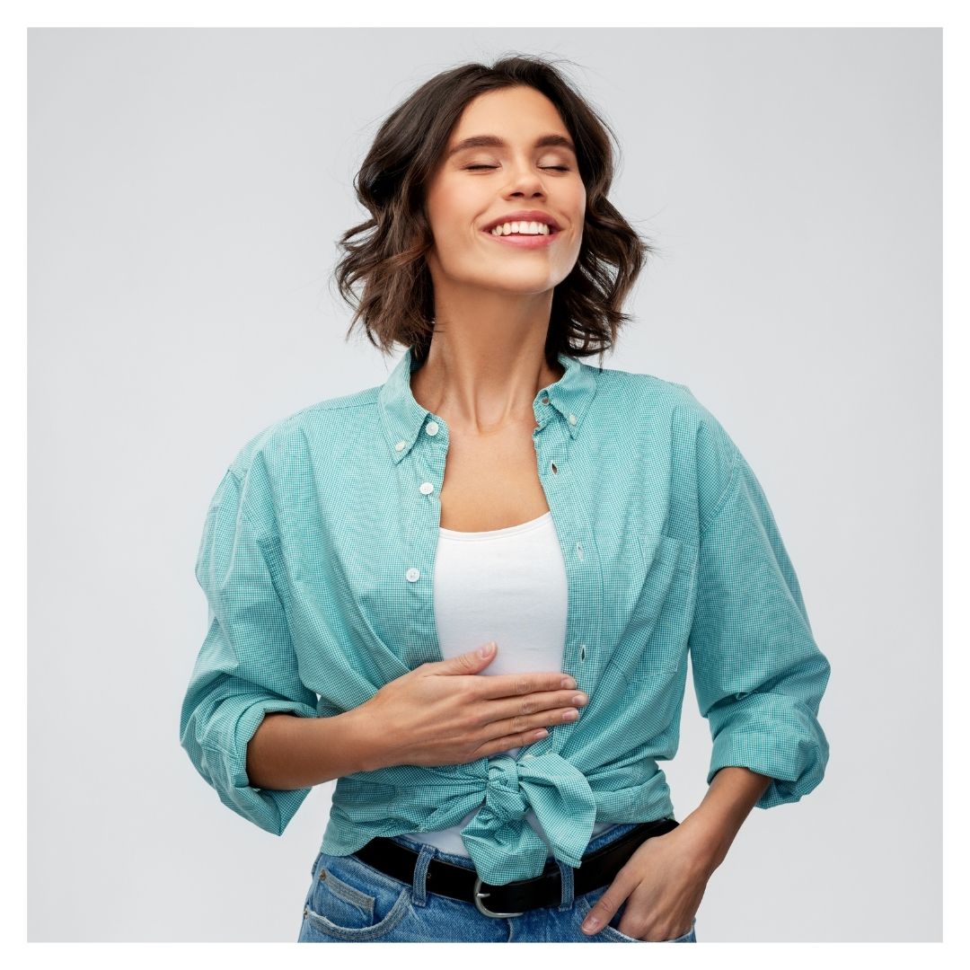 a woman smiling with her hand on her stomach