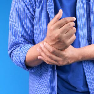 Person holding painful hand