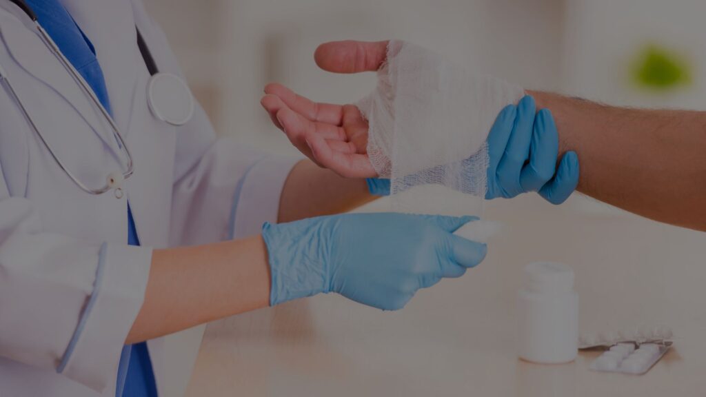 doctor wrapping patient's hand