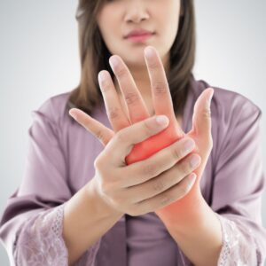 woman holding painful hand