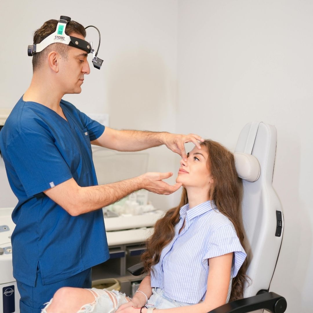 doctor looking at patient's nose